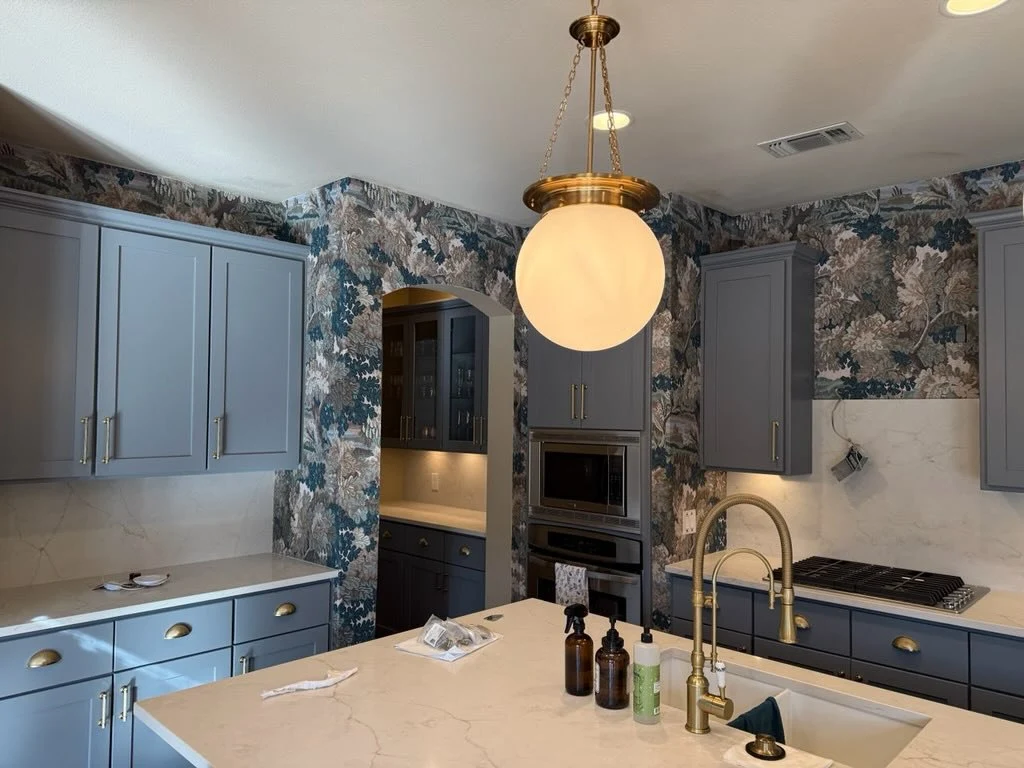 Master bedroom with patterned wallpaper on accent wall